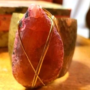 Brass cuff bracelet with pink stone.